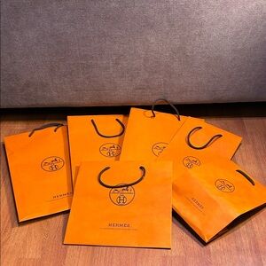 Hermès Vibrant Orange Shopping Bags with Black Handles